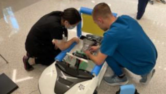 Two students modifying a toy car for children