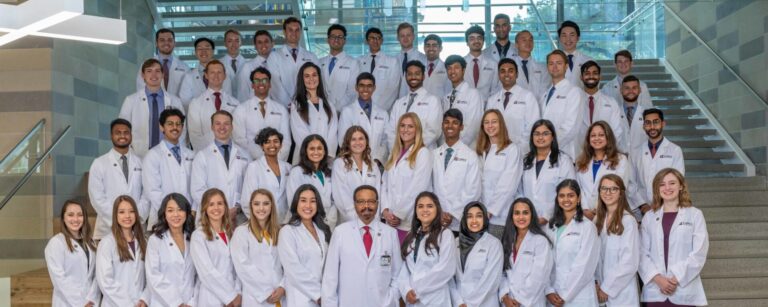 Roderic Pettigrew with the Class of 2025 wearing white coats at the EnMed White coat ceremony