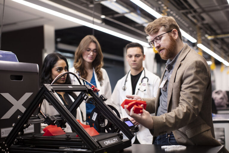 Dr. Nicholas Sears instructs three EnMed students in the Innovation Center Lab
