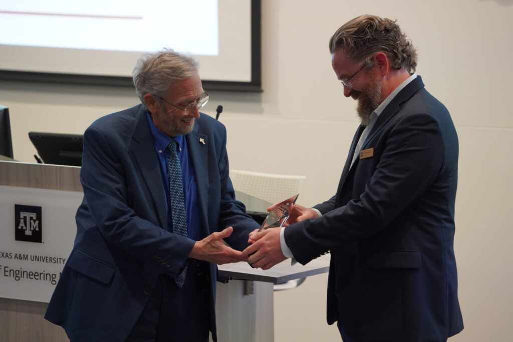 Dr. Rhome smiles while receiving R. Kelly Hester Distinguished Teaching Award